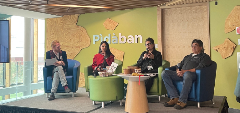 Four people are pictured sitting on stage during a speaking panel. From left to right: Mathew Jerabek, Manager, Experiential Learning and Entrepreneurship; Amenda Soucy, Inuk student entrepreneur and Business Management and Entrepreneurship student; Vanessa Stevens, Indigenous Councillor; and Chuck Commanda, Master Canoe Builder and Indigenous Knowledge Keeper.