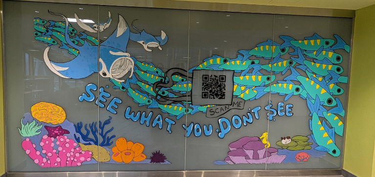 Painted mural on glass windows depicting aquatic animals and sea life, with the phrase 'see what you don't see' and a QR code to scan.