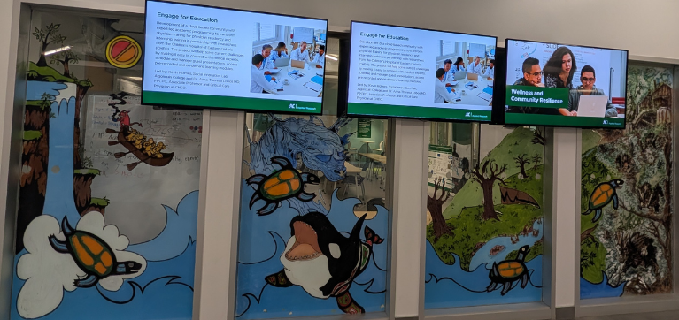 Painted mural on glass windows depicting aquatic animals and sea life.