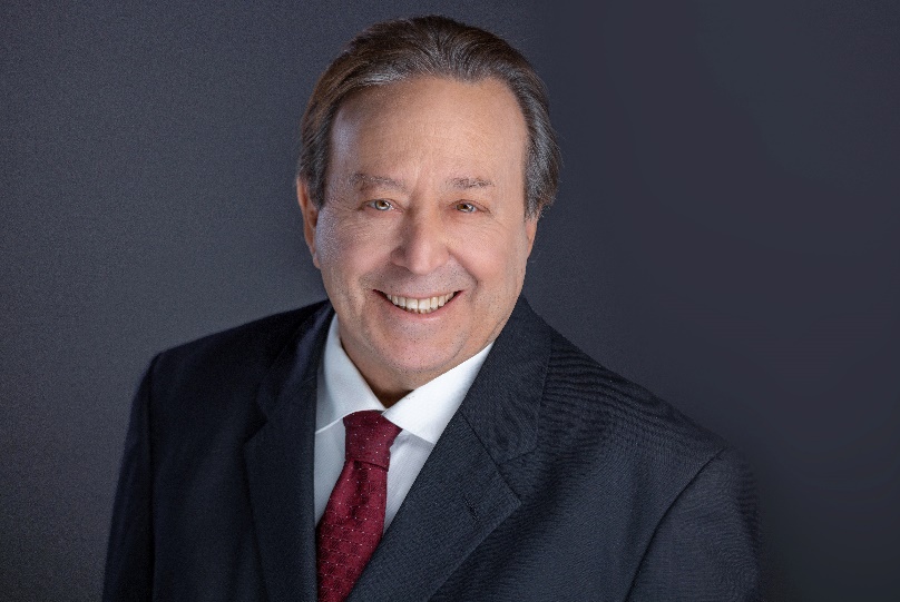 A person in a suit and tie Description automatically generated with medium confidence