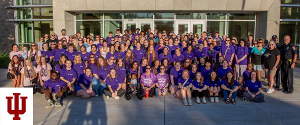 a group picture of people in purple shirts