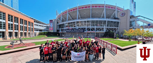 a group picture in front of a stadium