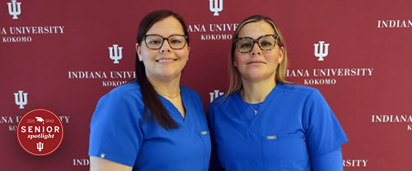 two women in blue scrubs against a red background