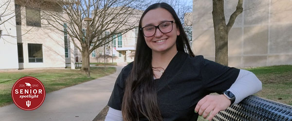 a woman sitting on a bench outside