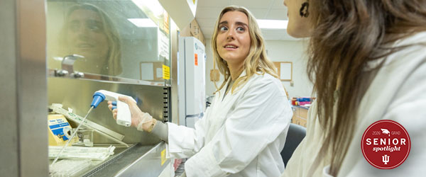 a woman in a white lab coat in a lab
