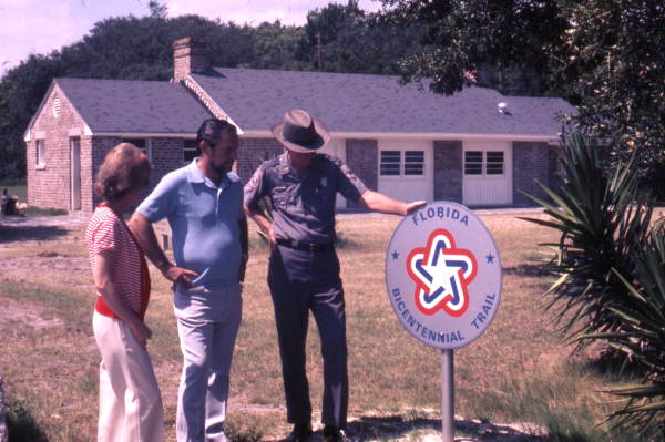 View of park visitors with ranger looking at Florida Bicentennial Trail sign at the Fort Clinch State Park - Fernandina Beach, Florida.