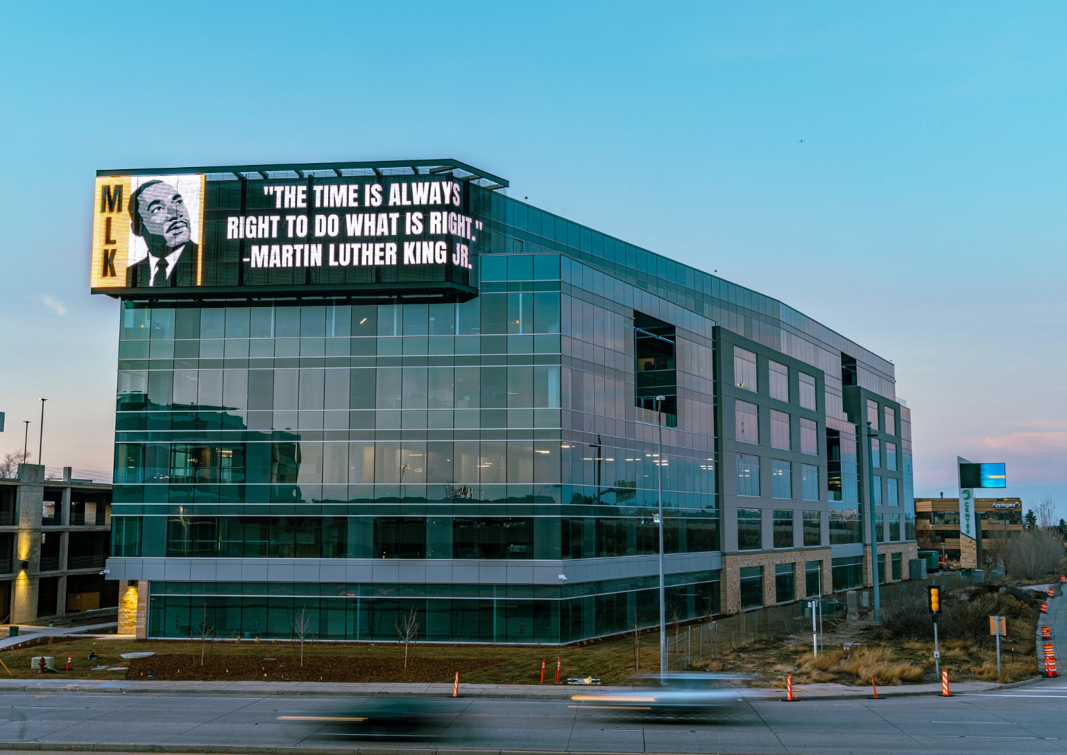 A large building with a sign on it Description automatically generated with medium confidence