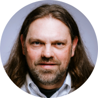A person with long hair and beard Description automatically generated