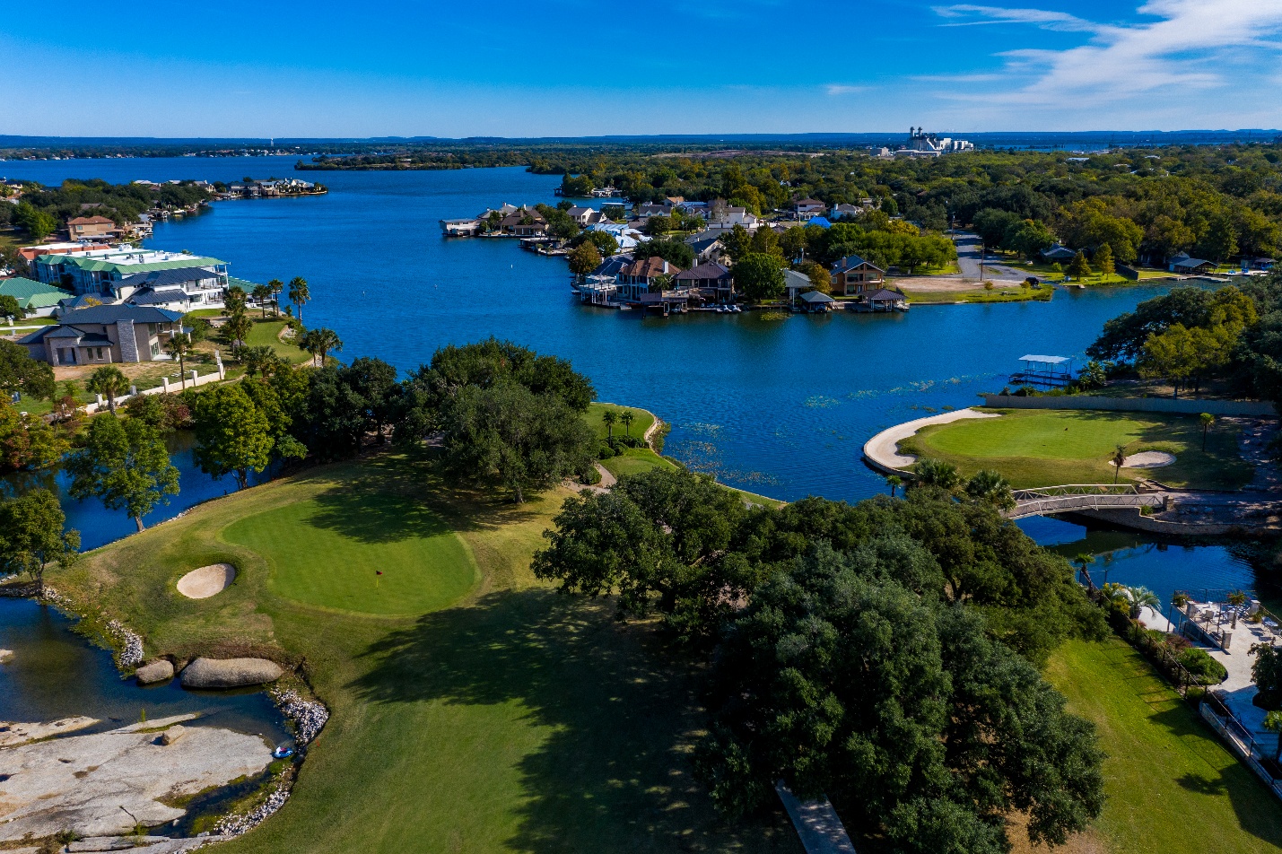 A body of water with houses and treesAI-generated content may be incorrect.