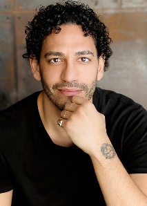 A person with a tattoo on his handDescription automatically generated