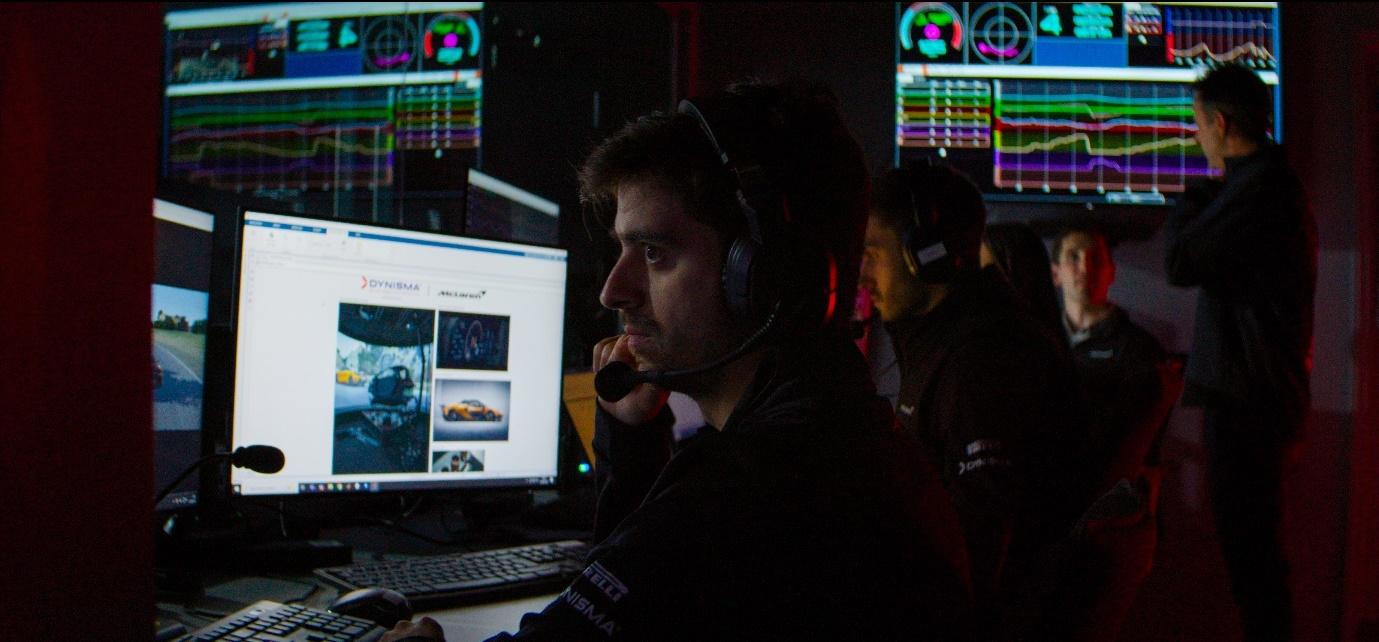 A person in headphones sitting in front of a computerAI-generated content may be incorrect.